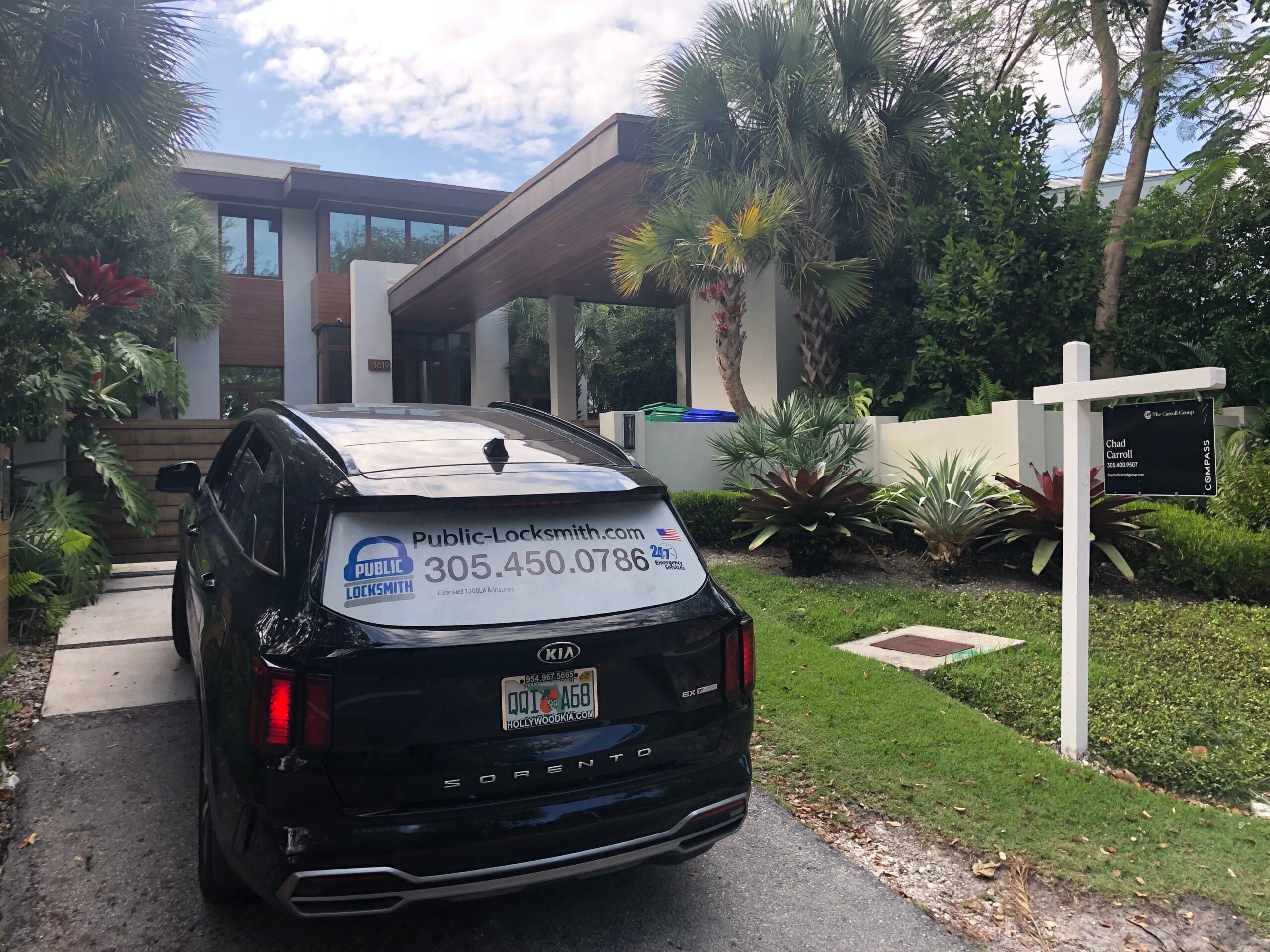 Lost Your House Keys? Here's What to Do Before You Panic A black Sundial Locksmith SUV parked in the driveway of a modern two-story home with a real estate sign on the front lawn.