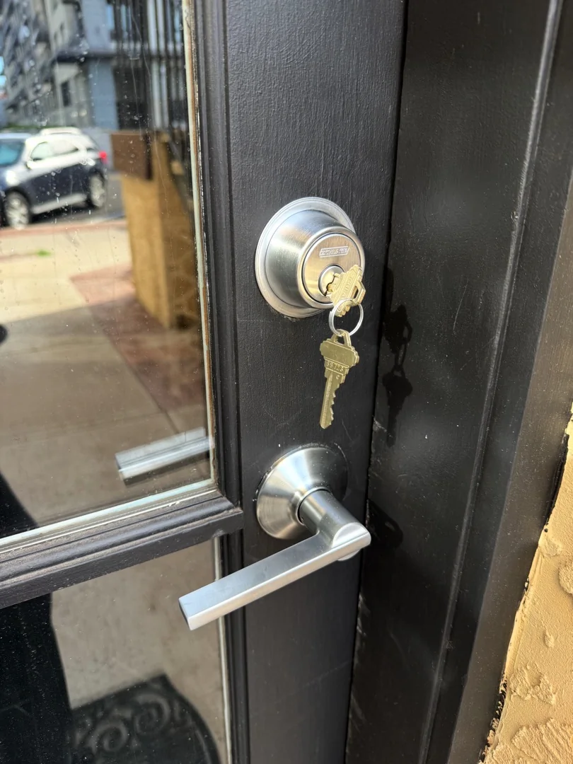 Same-Day Deadbolt Replacement: When to Skip the Hardware Store Trip A locksmith performing same day deadbolt replacement on a residential front door in bright Arizona afternoon sunlight