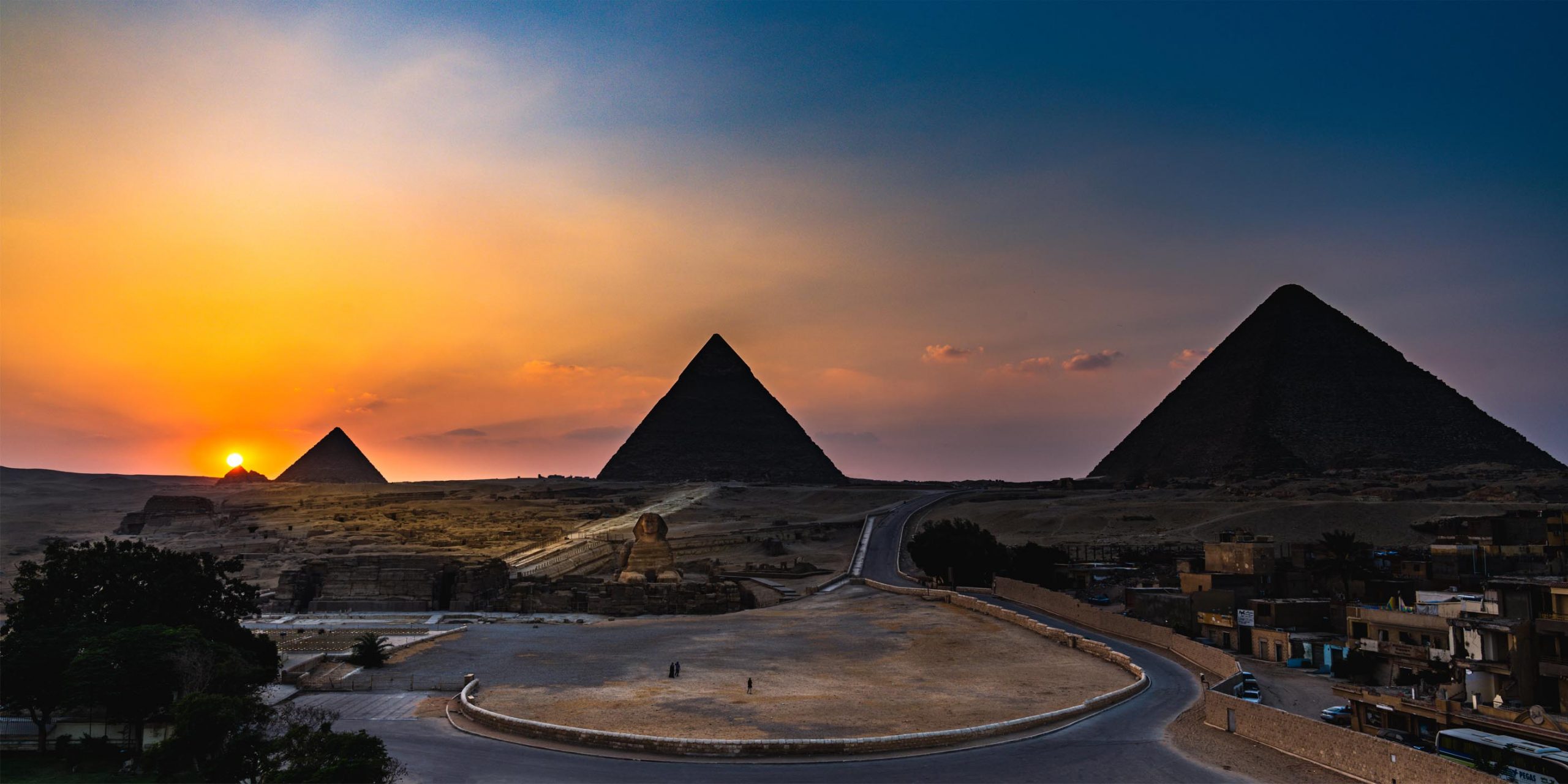 Four colossal ancient Egyptian statues carved into a temple cliff. Four colossal ancient Egyptian statues carved into a temple cliff.