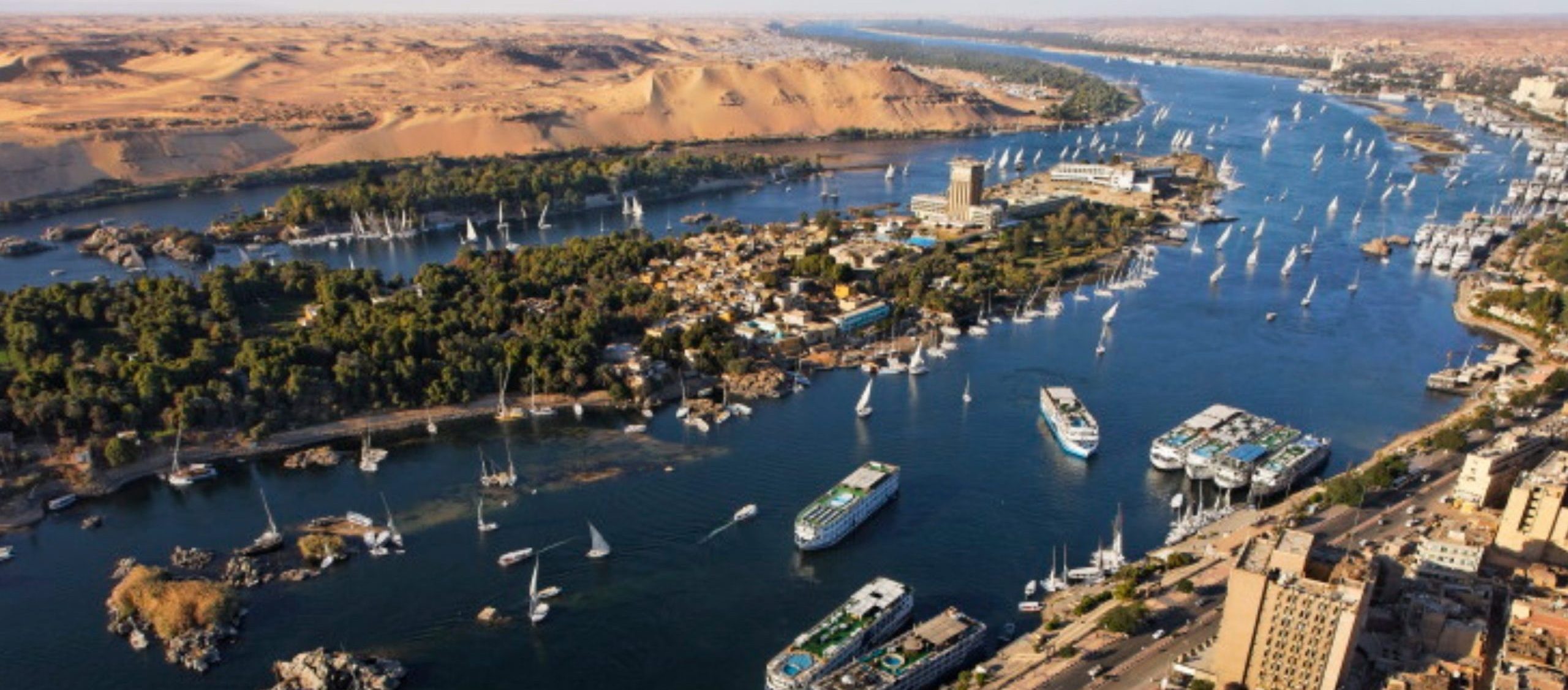 wide river with numerous sailboats and cruise ships wide river with numerous sailboats and cruise ships
