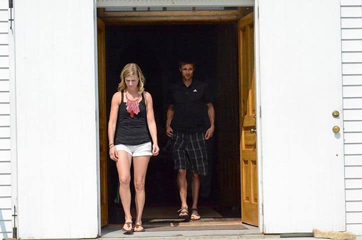 A person walking out of a building, emphasizing health and wellness at Cannon Pointe Chiropractic.