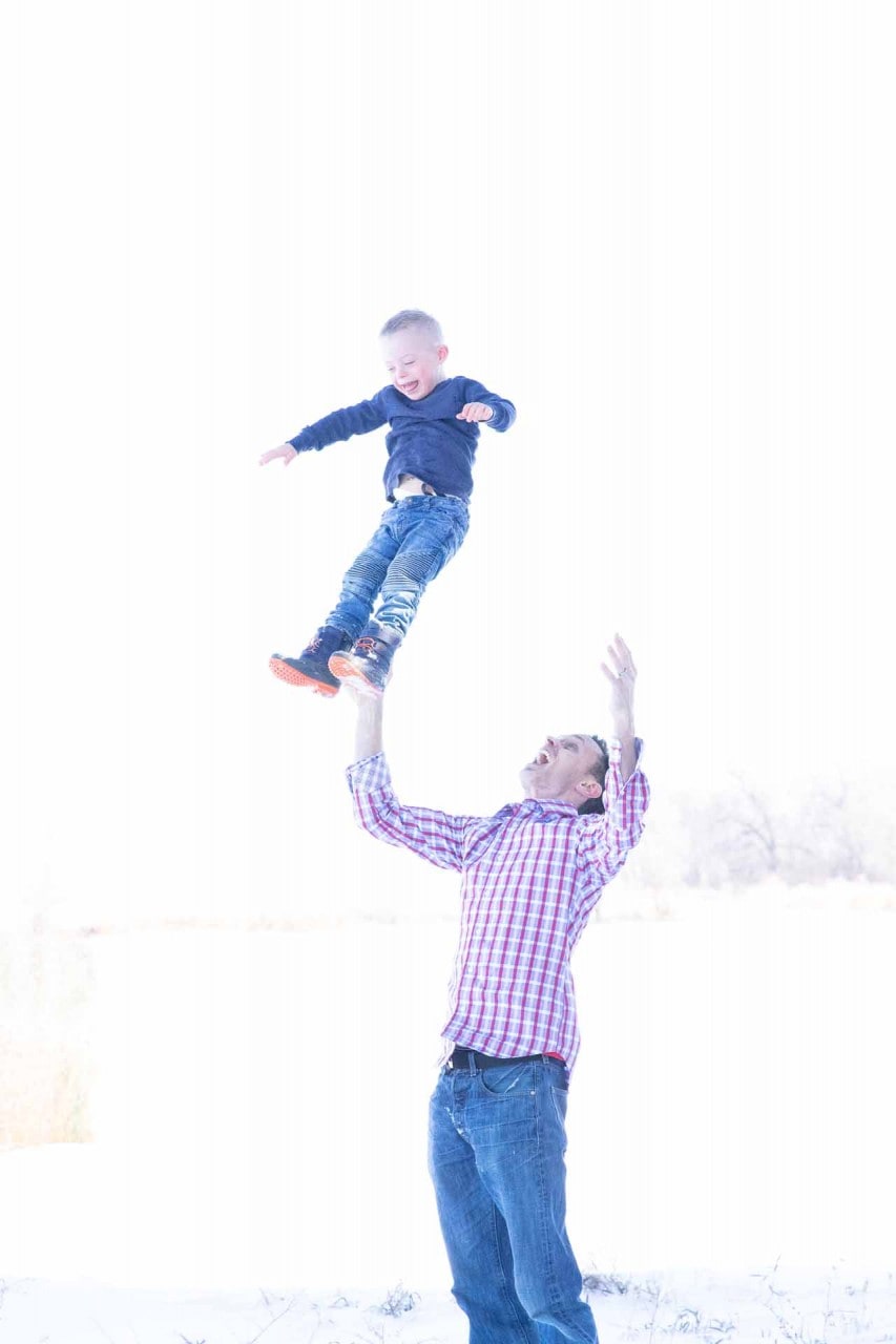 Joyful child being lifted by father, family health, chiropractic care, wellness, happiness. Happy boy jumping, health and wellness, chiropractic, family, children’s health, fitness.