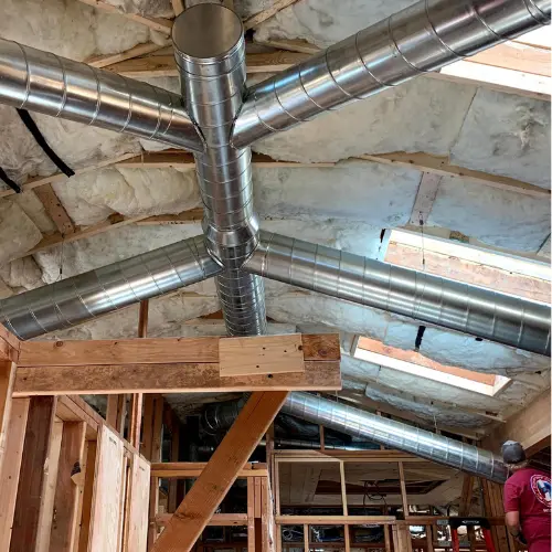 HVAC Project Portfolio 17 EPA certified technician Henri installing ductwork, a part of our indoor air quality services in Paradise Valley Arizona