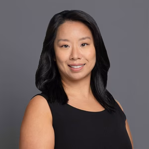 Headshot of Dr. Lawing in professional wear with a grey background.