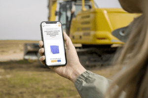 iPhone mockup displaying construction scenes, showcasing unified branding solutions with cranes and building site in backgrou