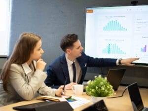 News 26 Young adult businessman presenting long-term marketing strategy tips in a modern office setting.