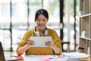 News 20 Smart Asian business woman smiling at office space, relevant to ad agencies Jacksonville FL guide.