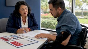 Medicare agent helping disabled man with paperwork