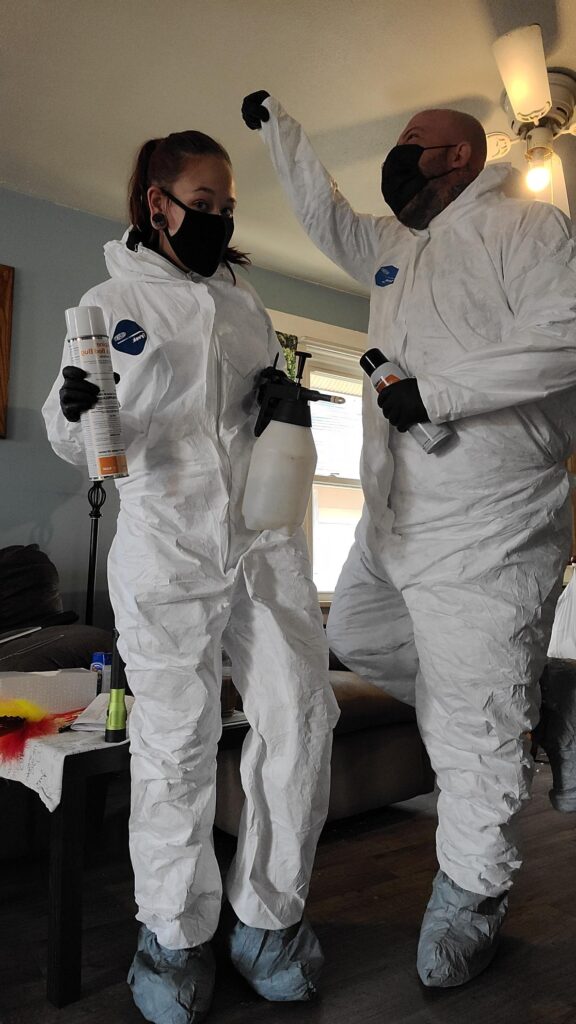 Two of our technicians dressed in safety gear enjoying their work.