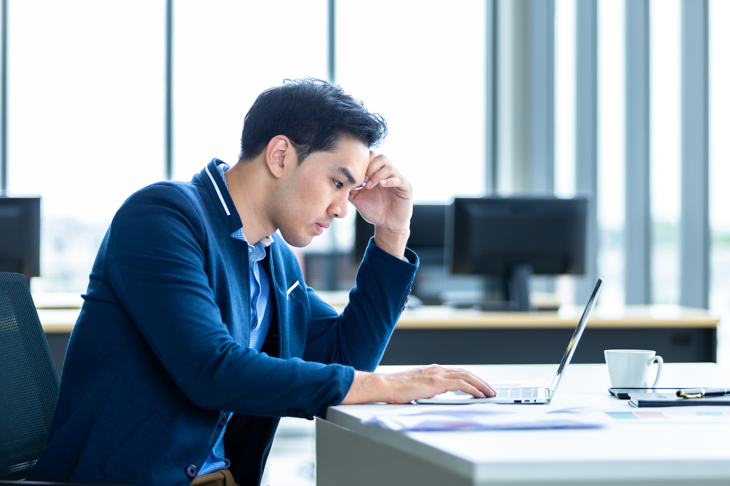 Stressed businessman worked with laptop computer and having a he Sell your house after losing your job