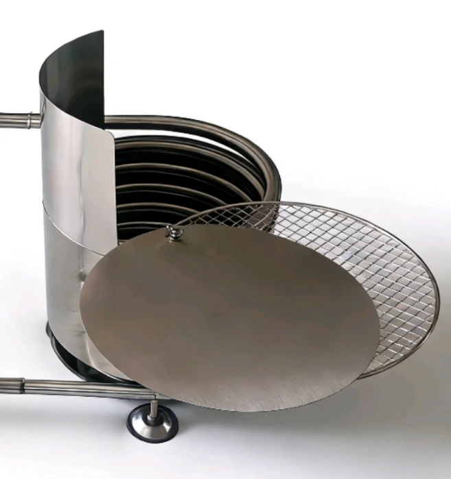 Wood Fired Pool & Hot Tub Coil Coil Model F4 With Fireguard in outdoor garden setup