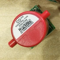 Close-up of a technician’s hands aligning the Testo 340 CO (H2) sensor type 0393.0104 into the instrument mounting slot, highlighting the precise installation fit.