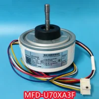 MFD-U70XA3F DC motor unboxed with wires, red, black, white, yellow, blue cables and mounting accessories laid out on a surface.
