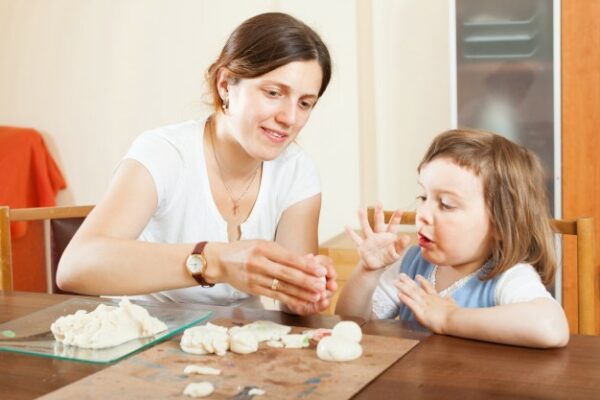Une mère et sa fille font de la pâte à sel