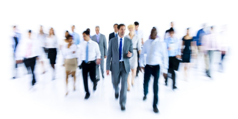 Business professionals walking in a conference or networking event.