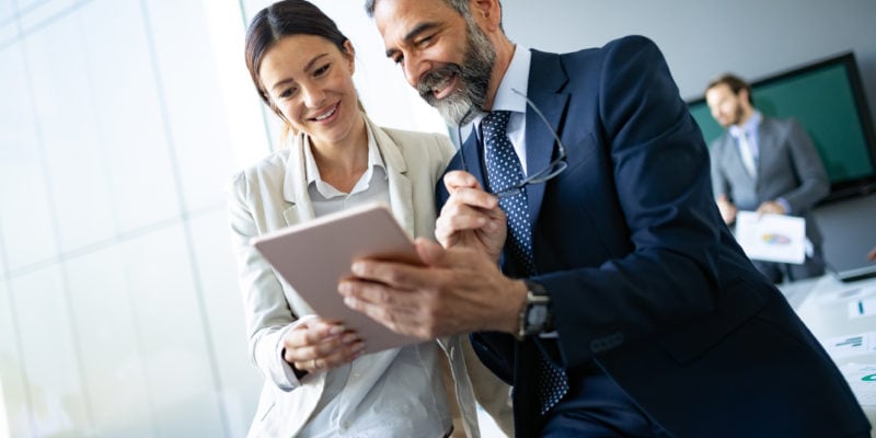 Business professionals engaging in a live sales conversation in a modern office.