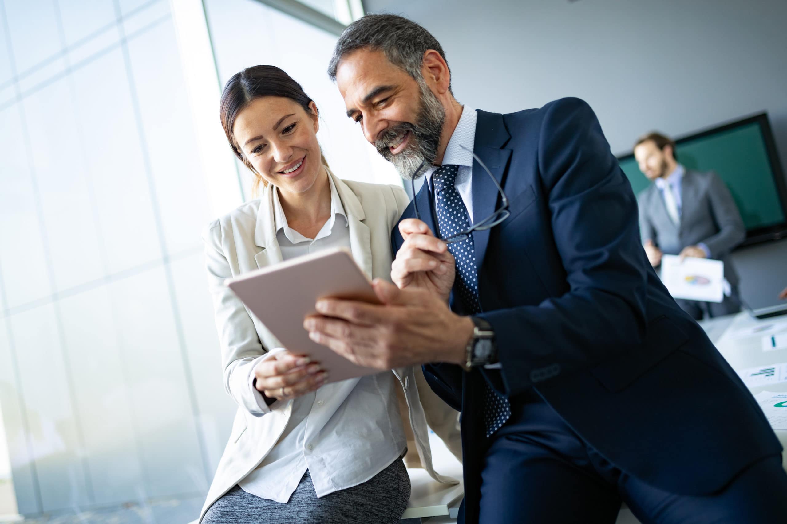 Effective Sales Conversations Business professionals engaging in a live sales conversation in a modern office.