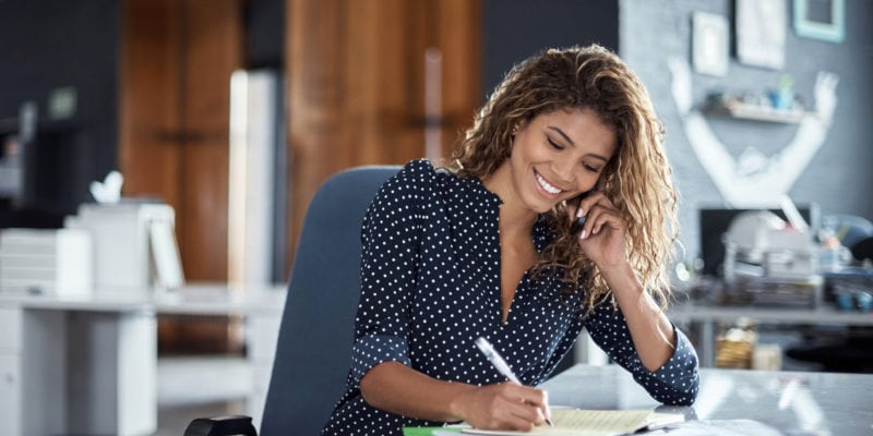 Woman making outbound call in office for B2B marketing success.