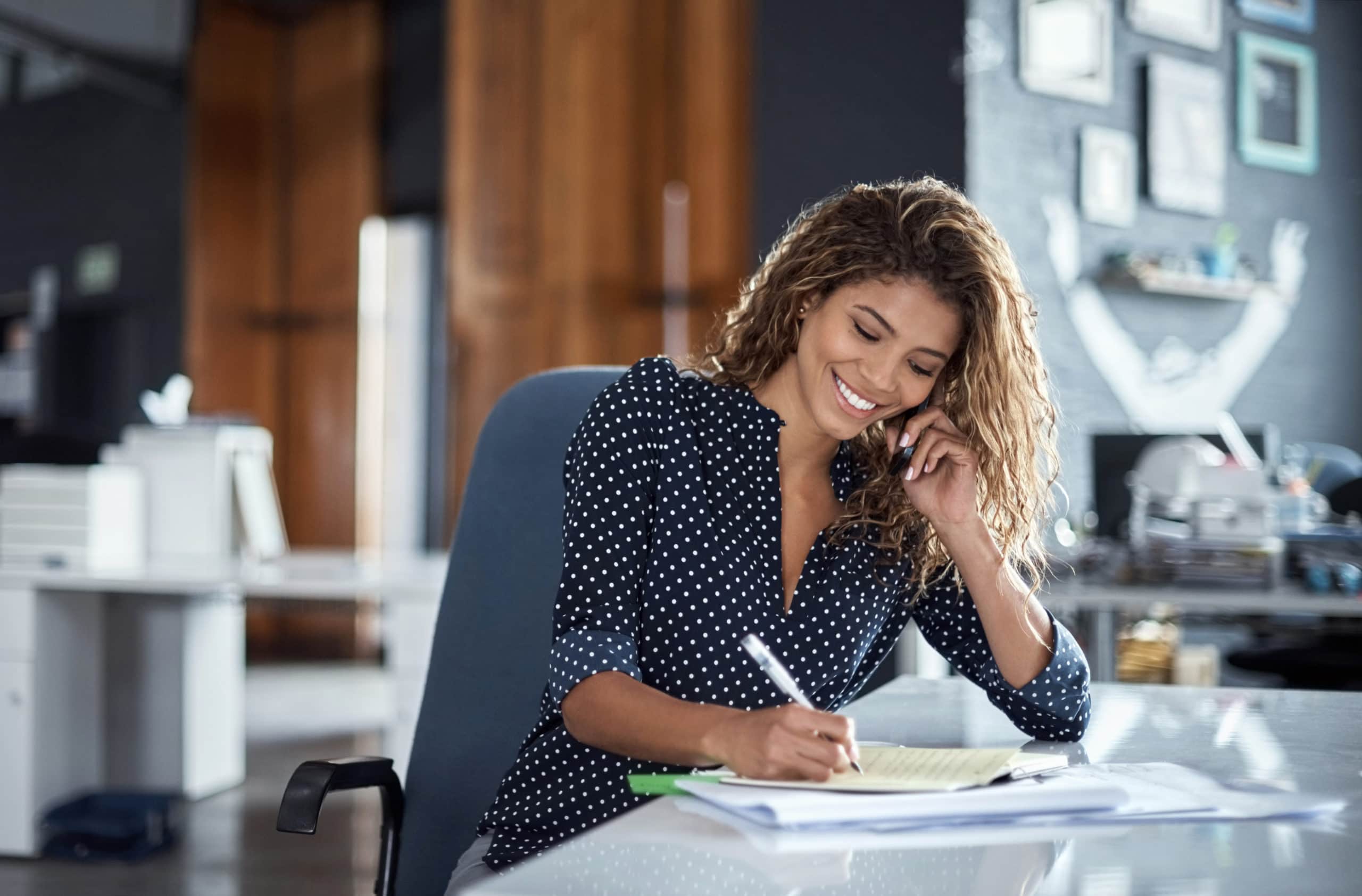 Boost Your B2B Marketing with Outbound Calling Woman making outbound call in office for B2B marketing success.
