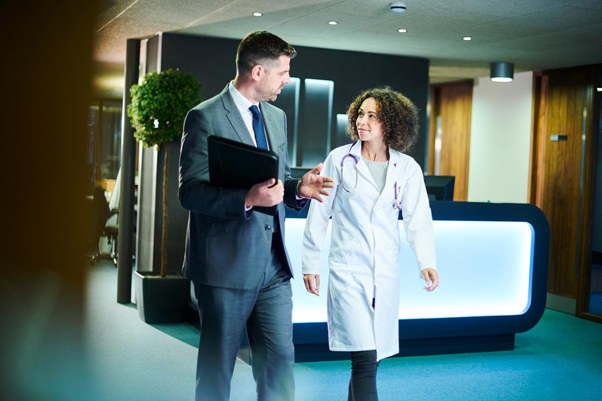 Medical professionals discussing patient care in a hospital setting. Medical professionals discussing patient care in a hospital setting.