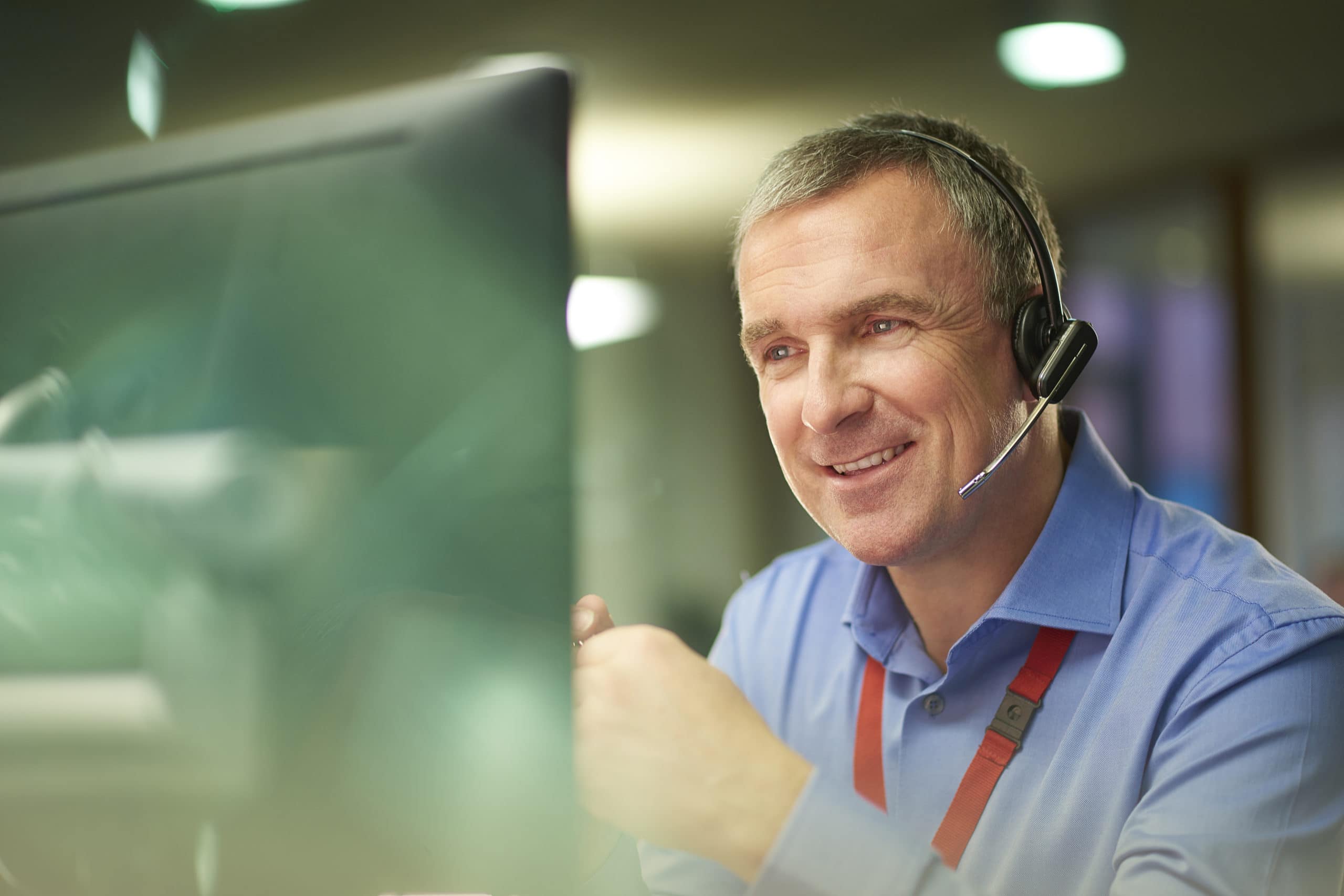 Effective B2B Sales Call Strategies Business professional using headset during a B2B sales call in an office setting.