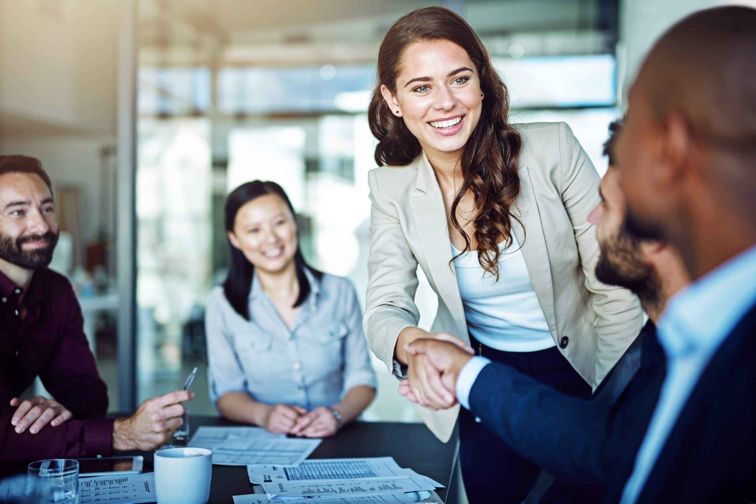 Effective B2B sales meeting with professional team collaboration and handshake. B2B sales cycle, professional networking, business partnership, corporate meeting, client engagement.