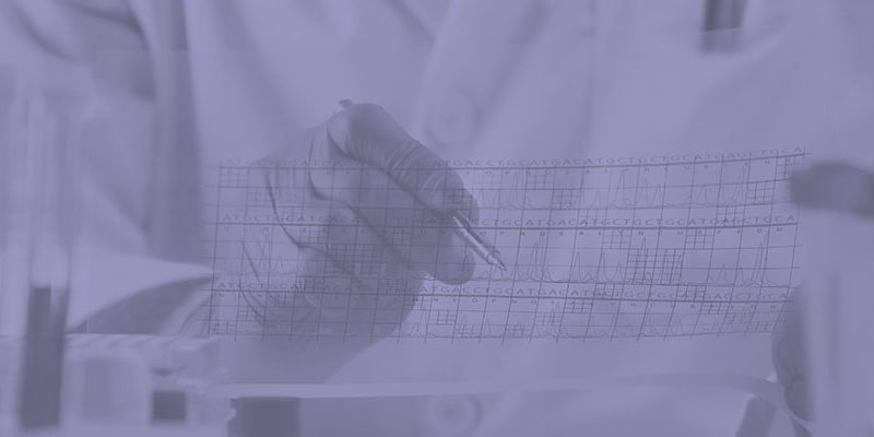 Scientist working with medical data charts in a lab setting.