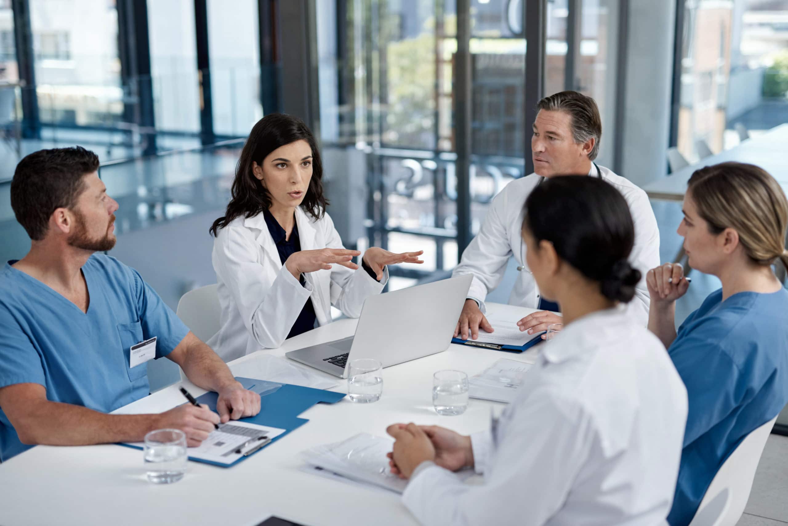 Medical Sales Team Meeting for Lead Generation Strategies Medical professionals discussing sales strategies in a modern conference room.