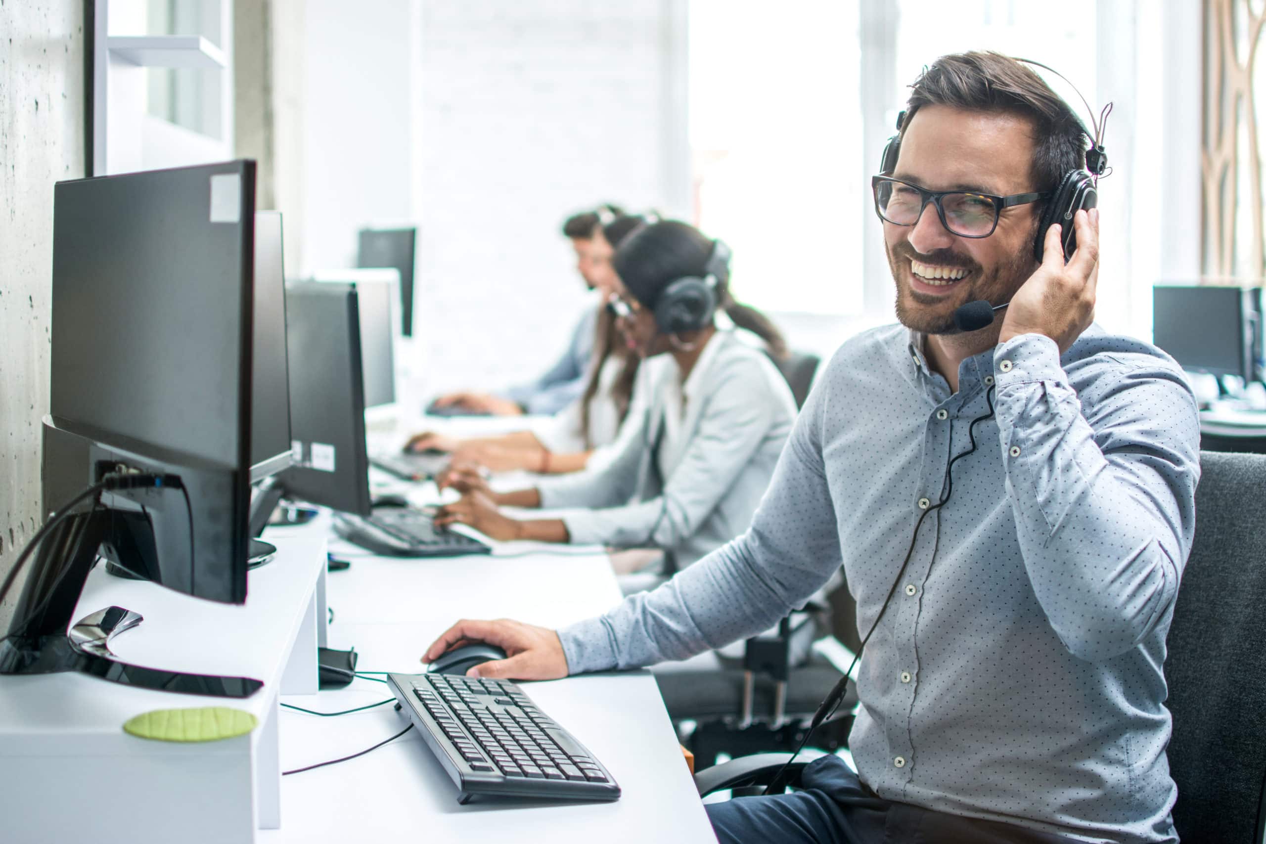 Revamp Inside Sales with Expert Service Inside sales team using headsets at computers for customer engagement.