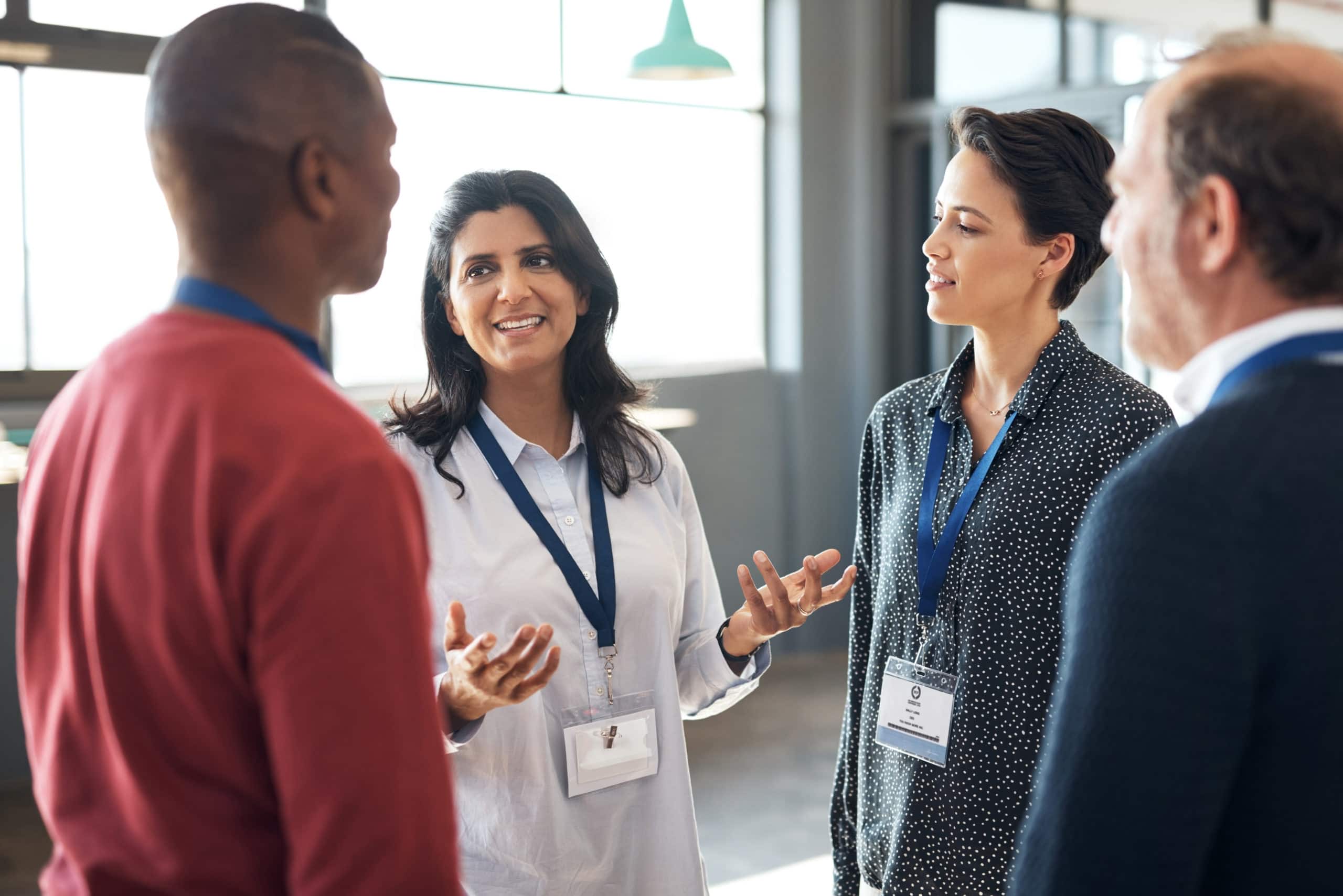 Event support with outbound calling at Volkart May Business professionals engaging in a discussion at a conference.