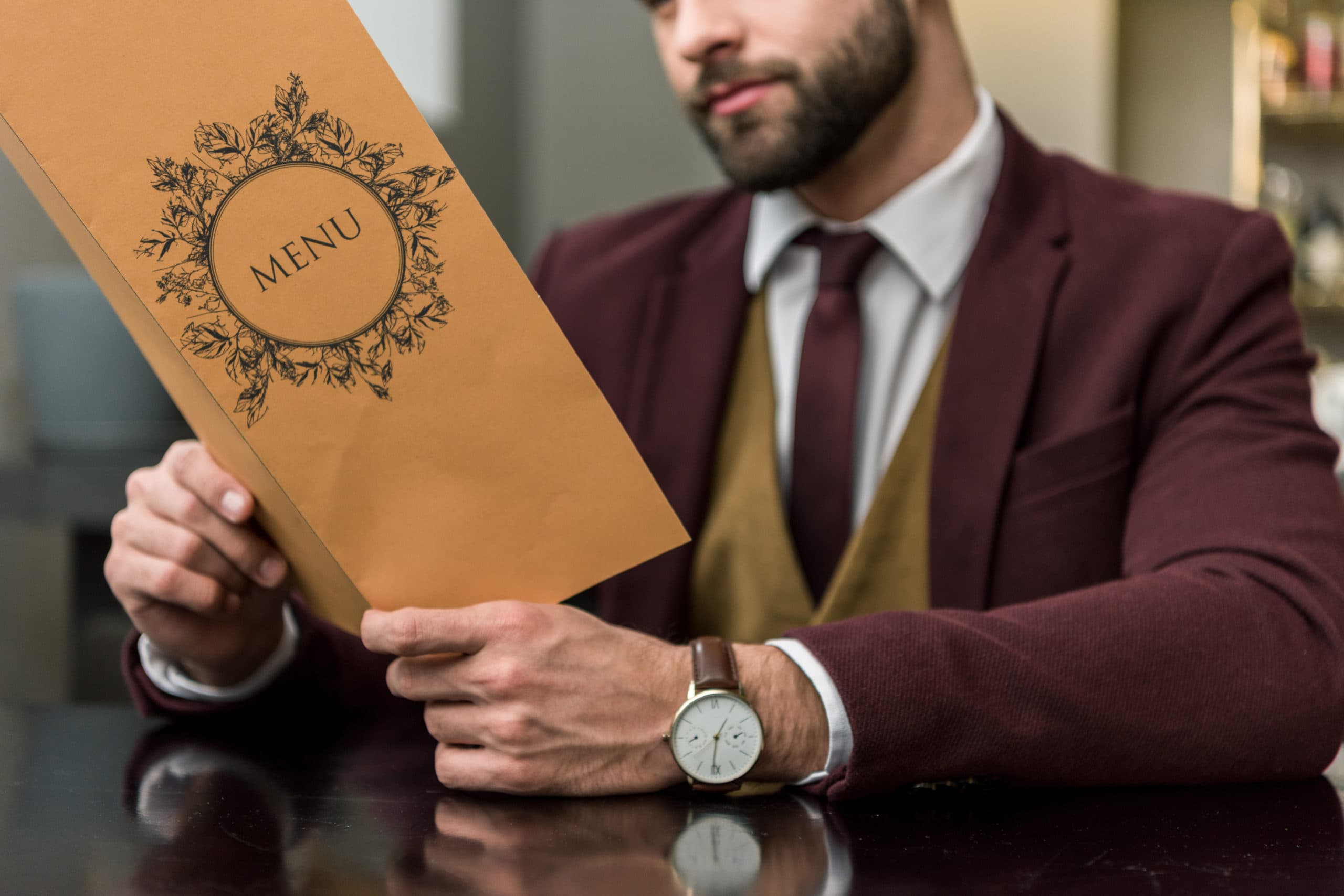 Menu Planning for Business Success Businessman holding a menu, focusing on top-of-the-funnel sales calls strategy.