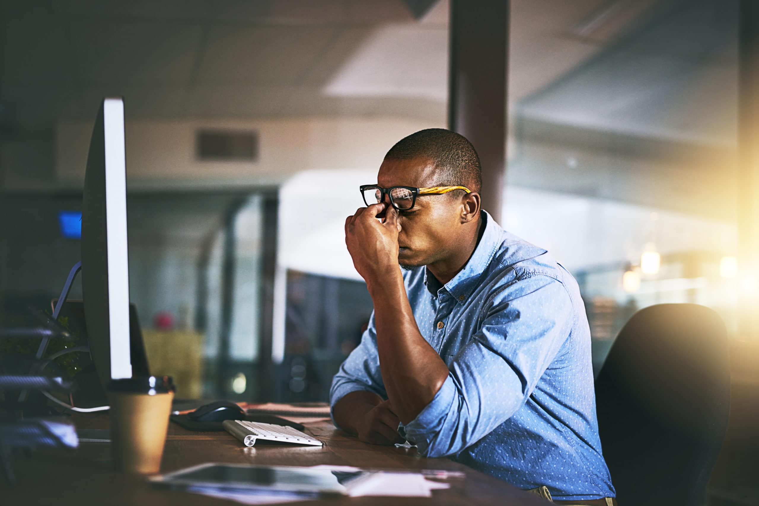 Struggling with lead generation campaigns Man working at a desk looking frustrated with lead generation issues.