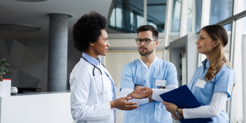 Healthcare professionals discussing prospect strategies in a hospital setting.