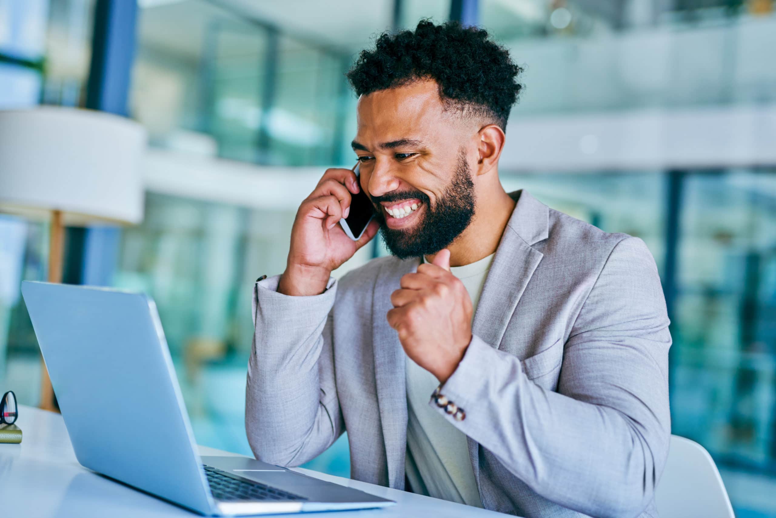 Effective Cold Calling Strategies Businessman making a successful cold call in modern office setting.