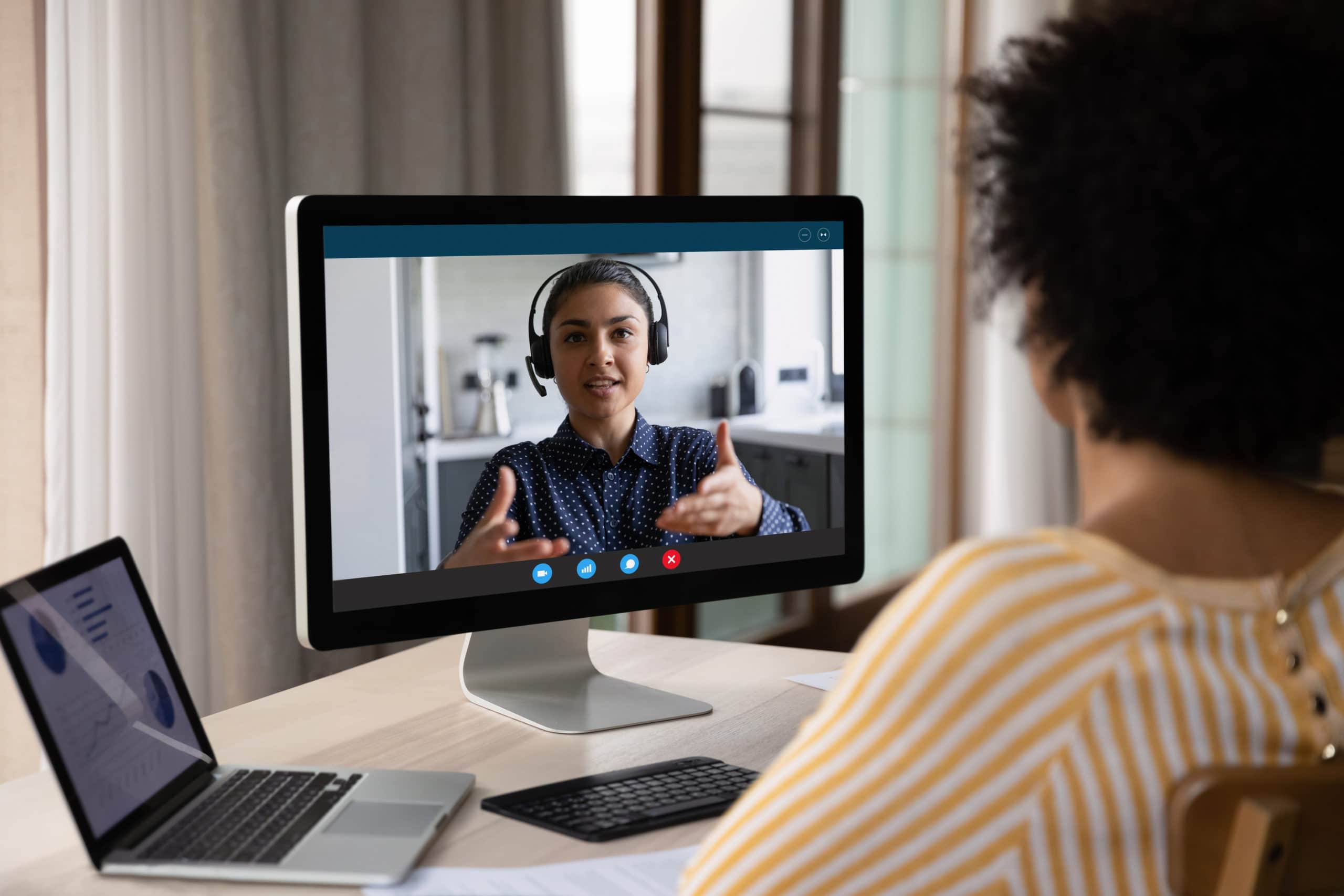 Effective Virtual Sales Call Tips Woman engaging in a professional virtual sales call via computer with headset.