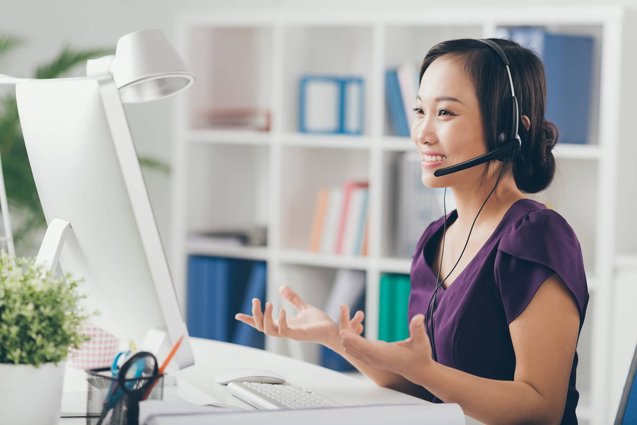 Building Your Fall Leads Pipeline with Customer Support Customer support representative engaging with clients via computer for lead generation.