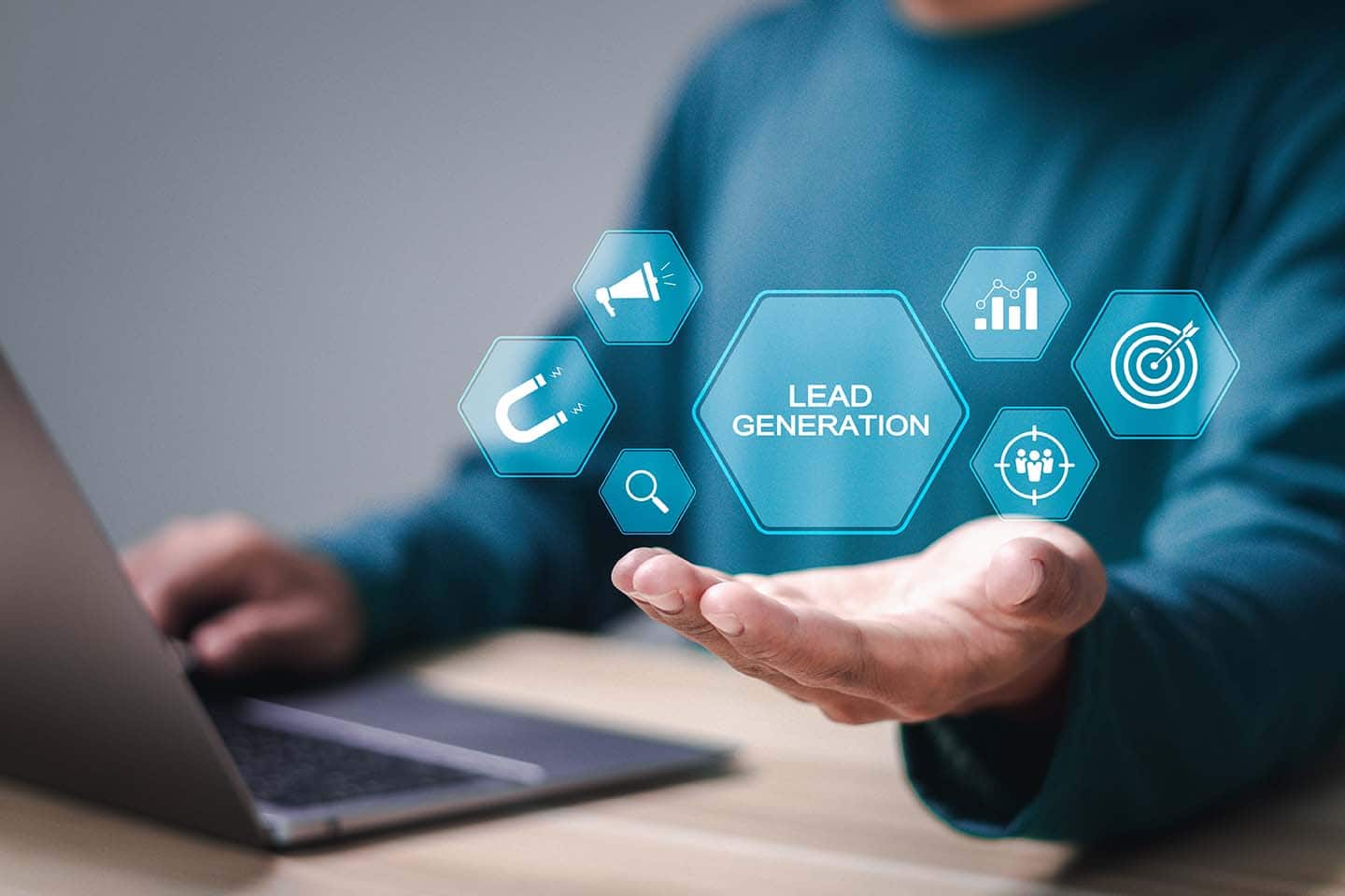 Lead Generation Automation for Sales Growth Laptop with man holding out hand with symbols and lead generation in the center focused on automating lead generation