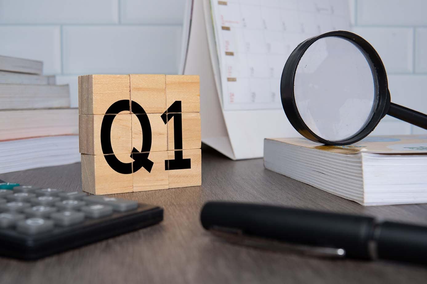 Q1 Lead Generation Strategy for Mid-Q1 Review Image of a desk with a Q1 block with focus on Lead Generation Goals Mid-Q1