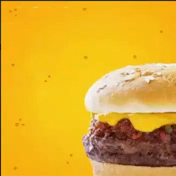 burger A cheeseburger with a beef patty, melted cheese, and sesame seed bun rotates against a bright yellow background with animated sparkles, showcasing the creativity of expert graphic design services.
