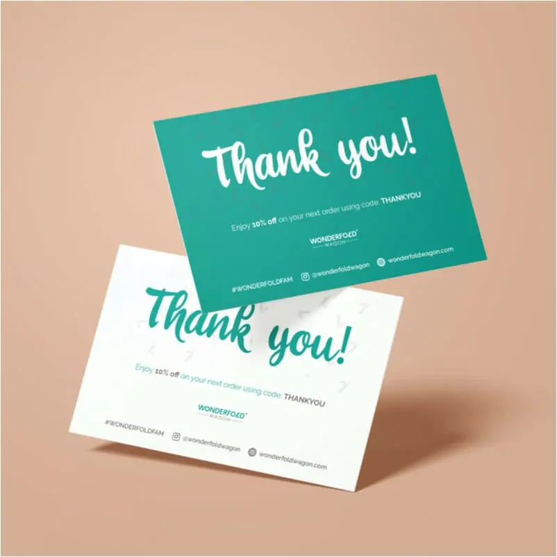 greetings Two thank you cards, one teal and one white, featuring 10% off your next order with code THANKYOU. Perfect for any graphic designer or graphic artist, the cards display social media handles and contact info on a neutral background.