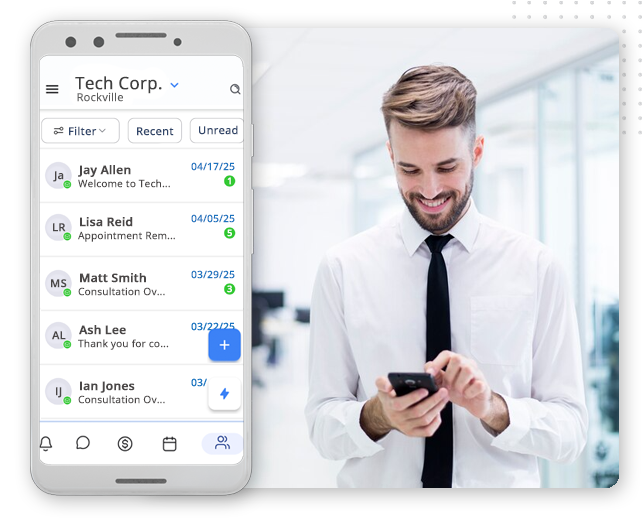 Automator-comm-hub-img A smartphone screen shows a CRM Software for Small Businesses app with chat messages listed. Next to it, a smiling man in a white shirt and tie stands in an office, looking at his phone.