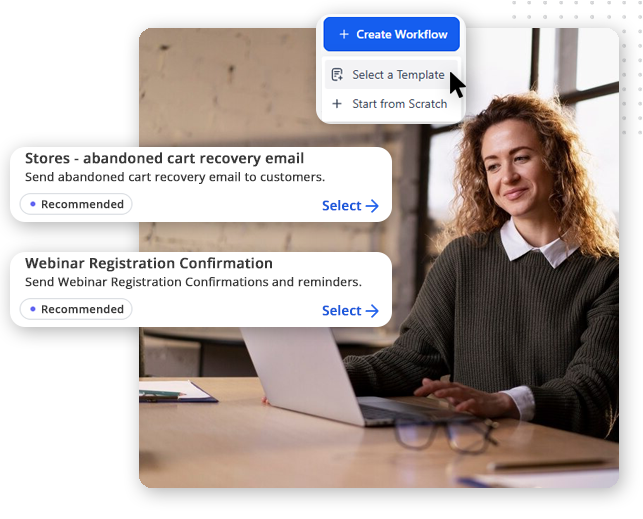 Automator-workflow-templates-img A woman sits at a desk with a laptop, smiling. On the image are digital pop-ups showing options in CRM software for small businesses, like creating workflows for abandoned cart emails or webinar registration confirmations.